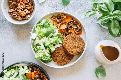 Top view of lentil patties with spicy carrots, mushrooms and fresh salad photo