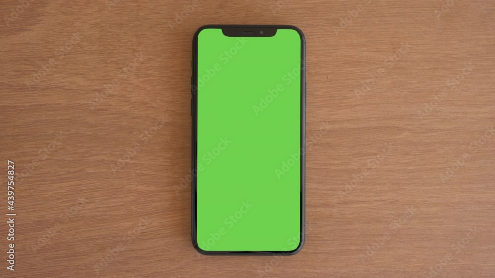 Smartphone place on wood table, Green screen telephone, Close up display mobile phone with mock up, Chroma key monitor, Close-up the cell phone on brown desktop, Mockup smartphone, Zoom top view. Smartphone place on wood table, Green screen telephone, Close up display mobile phone with mock up, Chroma key monitor, Close-up the cell phone on brown desktop, Mockup smartphone, Zoom top view.