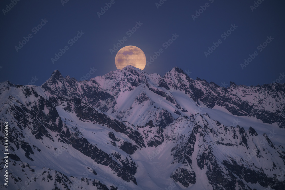 © plpictures by Paedii Luchs/Stocksy - Full moon rising in the swiss alps