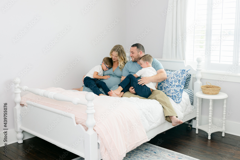 Family of four snuggle on a bed Family of four snuggle on a bed