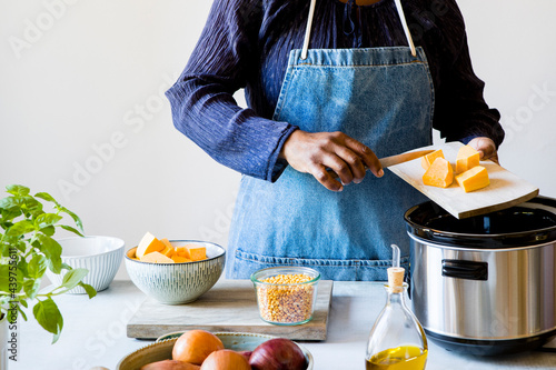 Woman preparing food with kitchen appliance photo