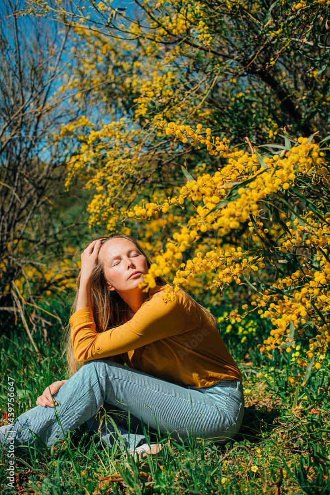 Portrait of a woman in a yellow flower bush Portrait of a woman in a yellow flower bush