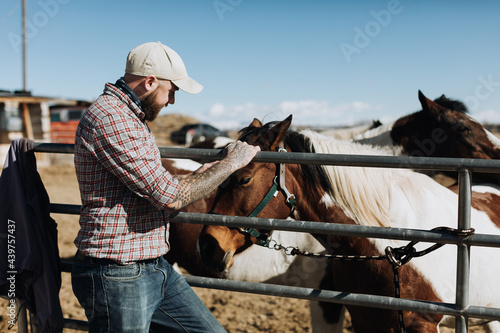 Rancher with Horses at Farm