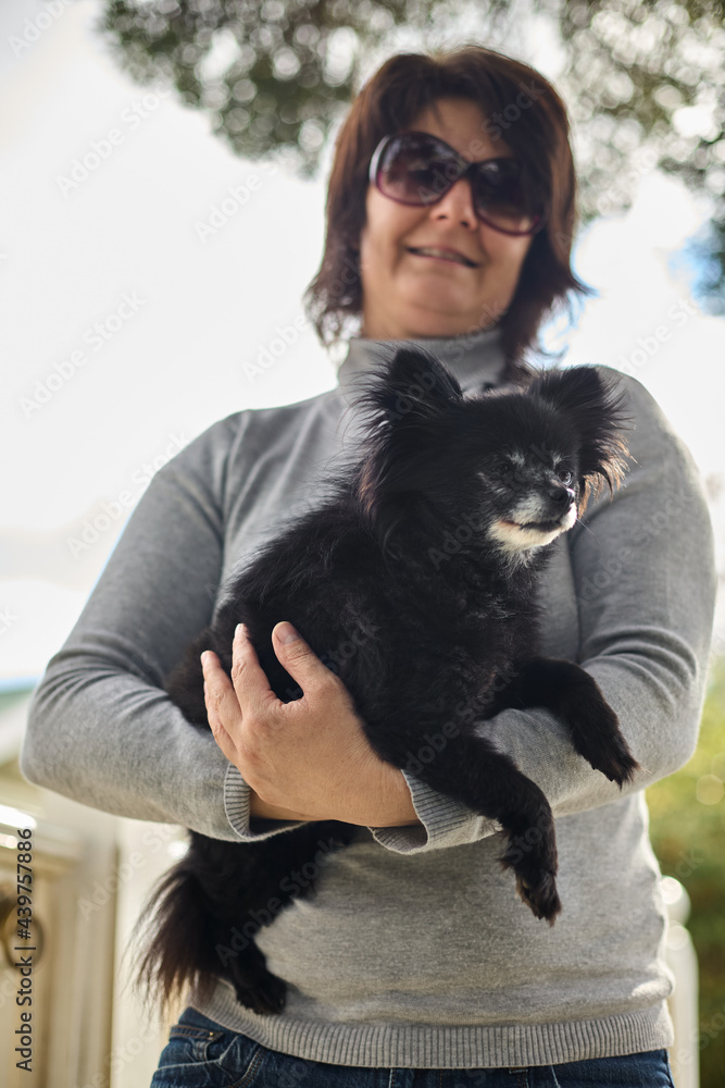 Woman holding her tiny old Chihuahua Woman holding her tiny old Chihuahua