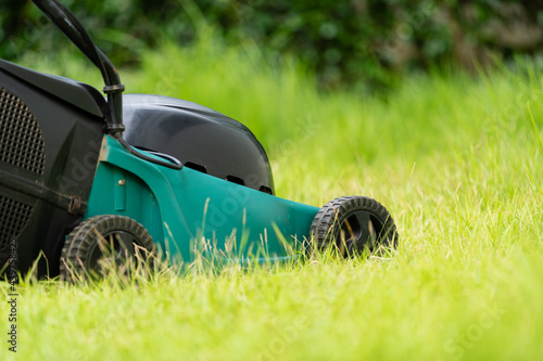 lawn mower on green grass at home