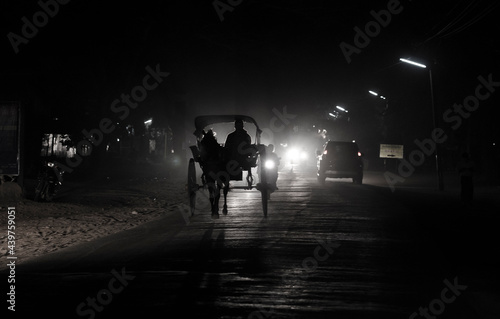 Horse carriage silhouette of a person walking on the road  Bagan  Myanmar