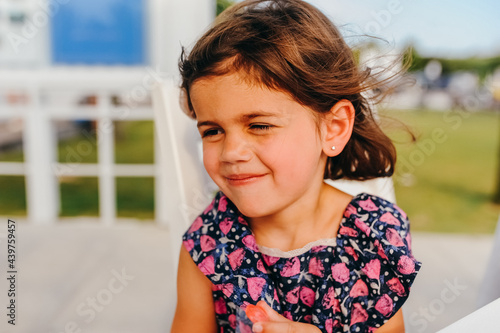 Happy girl sitting at a picnic table.  photo