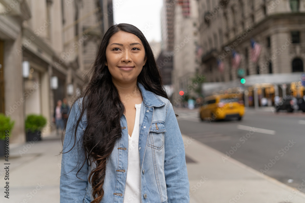 Young Asian woman in city walking street smile happy face