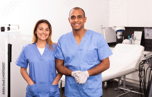 Portrait of qualified female and male cosmetologists smiling confidently in medical center © JackF