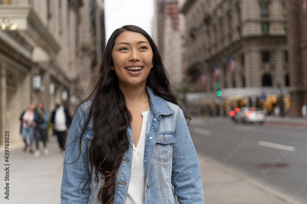 Fototapeta premium Young Asian woman in city walking street smile happy face