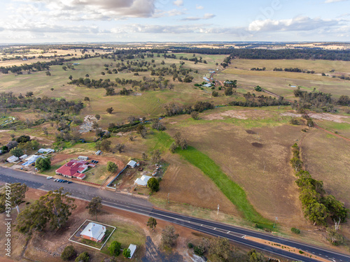 aerial view over outskirts of small town with farmland to the horizon photo