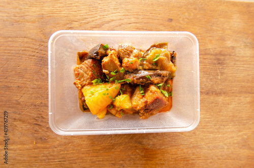 Top view of a container with pot roast avegetables photo