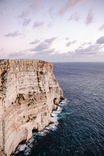 View of majestic Ta Cenc Cliffs walls and stunning cloudscape over the sea, Sannat, Malta photo