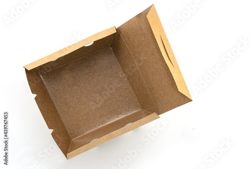 Opened eco takeaway food box on white background. Empty brown paper food box with waterproof coating inside. Top view image.