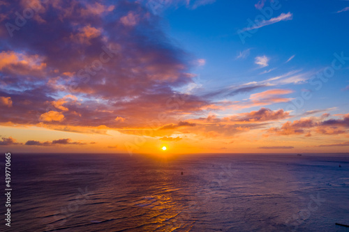 Sun setting over the Pacific Ocean as seen from Waikiki Beach  © Kyo46