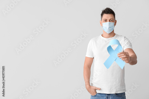 Man with blue ribbon on lig...