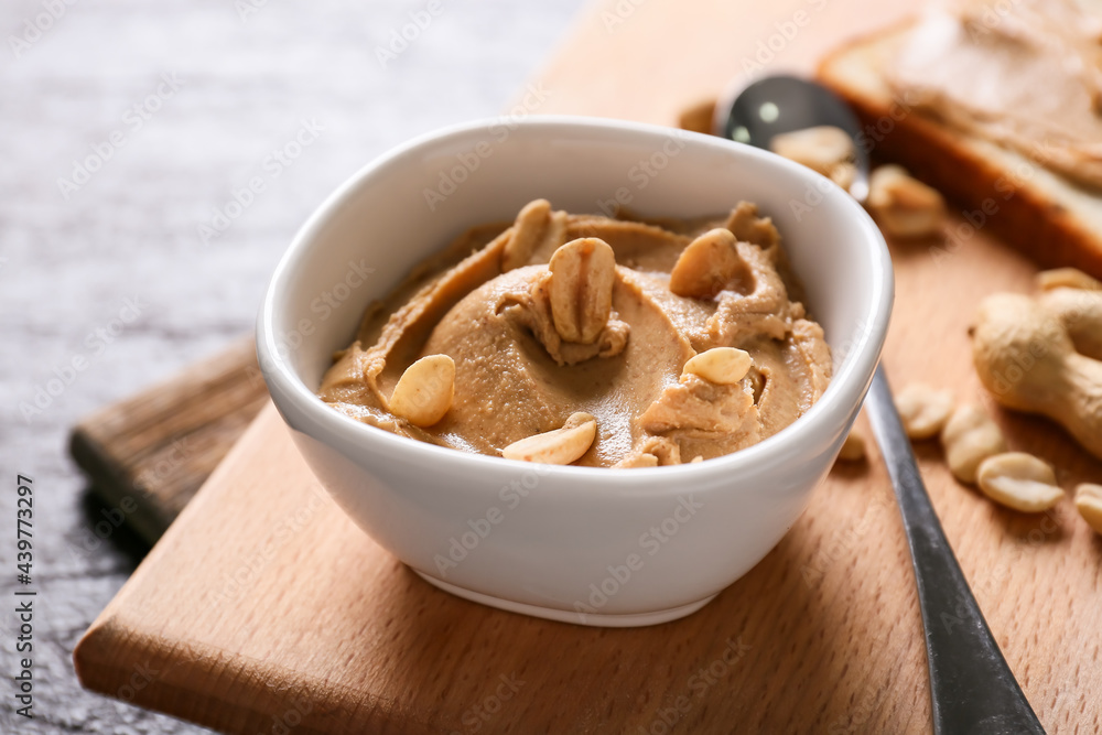 Bowl with tasty peanut butter on table, closeup Bowl with tasty peanut butter on table, closeup