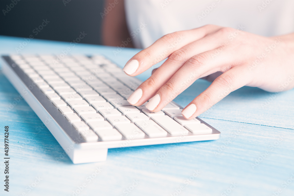 young woman writes on the keyboard young woman writes on the keyboard
