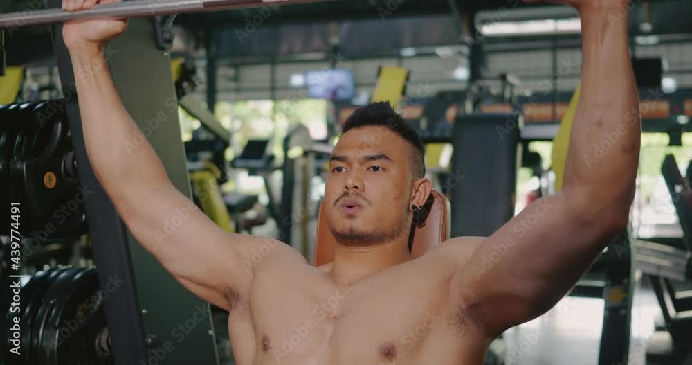 Muscular man working out exercise for triceps push down weightlifting with pull machine to flexing muscles at fitness gym, Sport fit workout bodybuilding concept