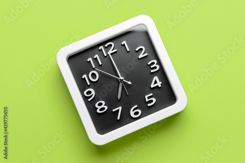 Stylish clock on color background