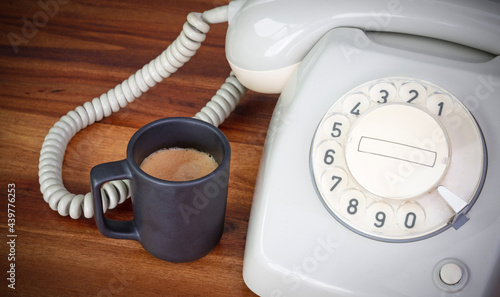 Old office - Have a break, a small espresso cup with an old telephone