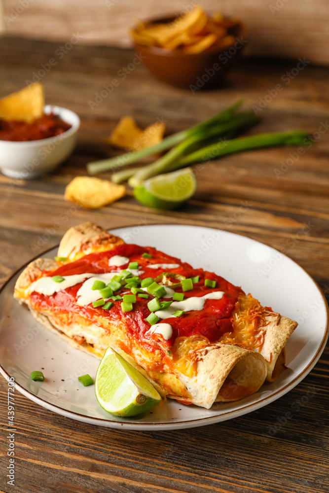 Plate with tasty cooked enchilada on table Plate with tasty cooked enchilada on table