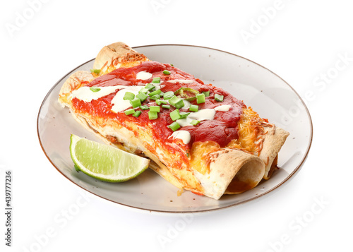 Plate with tasty cooked enchilada on white background photo