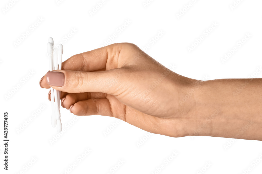 Female hand with cotton buds on white background