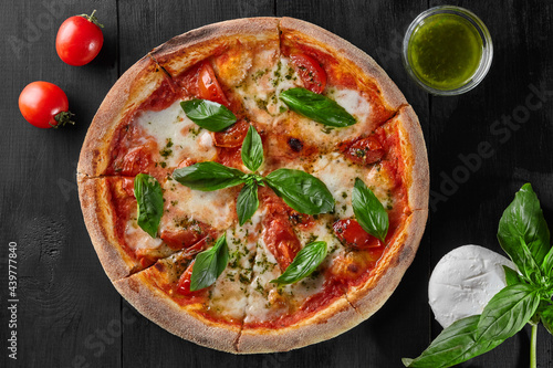 Pizza Margherita with tomatoes, mozzarella cheese and basil