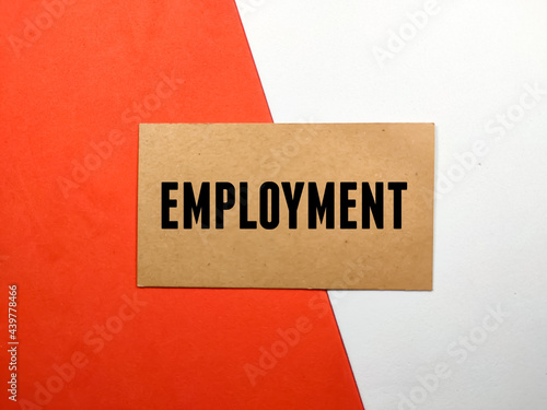 Business concept.Text EMPLOYMENT on brown card with red and white background.
