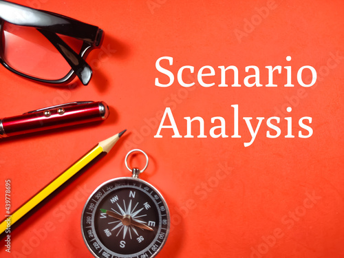 Business concept. Text Scenario Analysis with pen,glasses,pencil and compass on red background.