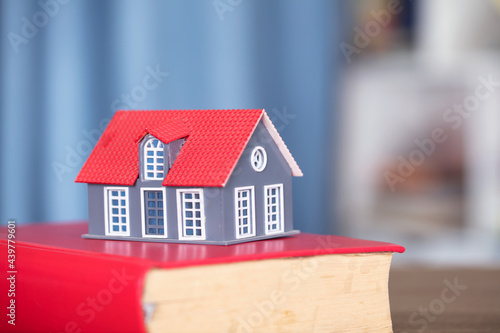 House model on a red book