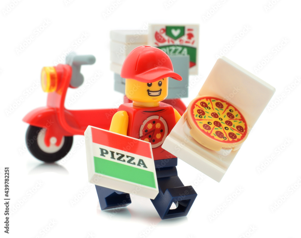 Lego minifigure smiling deliver of pizza on red motorbike isolated on white  Stock Photo | Adobe Stock