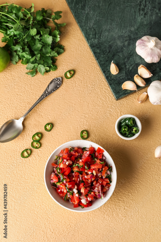 Bowl of tasty Pico de Gallo salsa on color background Bowl of tasty Pico de Gallo salsa on color background