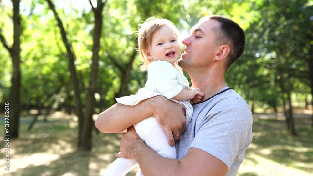 Happy young father spending time together with little daughter outdoors Happy young father spending time together with little daughter outdoors