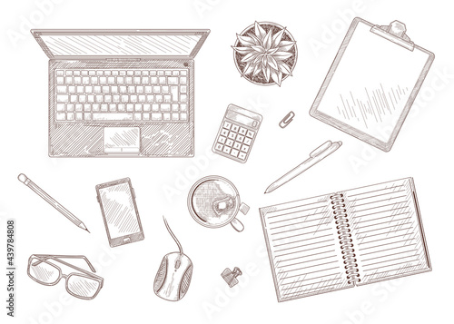 Hand drawn vintage sketch of desktop with laptop and stationary. Top view of computer, notebook, plant on table isolated on white background engraved illustrations set. Workplace, business concept