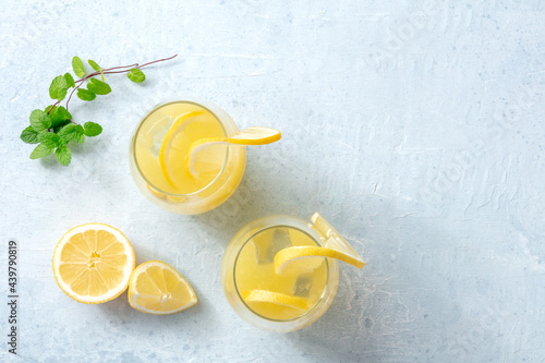 Lemonade. Homemade fresh drink with lemon and mint, with ice, overhead flat lay shot with copy space. Healthy organic detox beverage