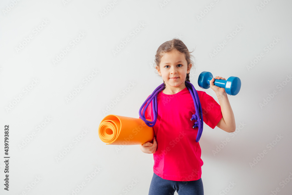 Cute boy with sport equipment sitting on a floor Cute boy with sport equipment sitting on a floor