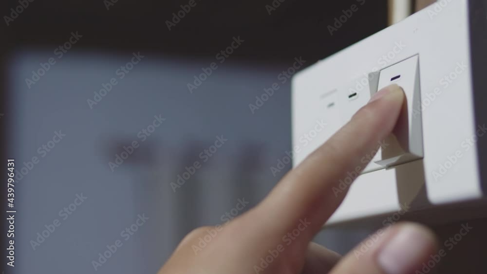 4k B roll of Saving electrical energy. Close up woman hand turn on and turn off the switch light. Finger pushing light switch turn on and turn off.