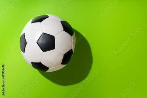 top view of soccer ball on green background  concept football time