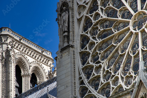 Slow travel in Paris - discovering the little things: View of a rose window and a steeple of a catholic cathedral