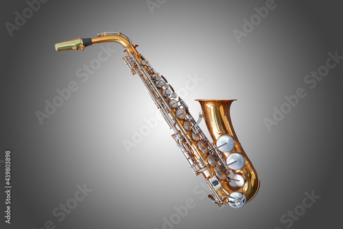 Old and well used saxophone on grey gradient background