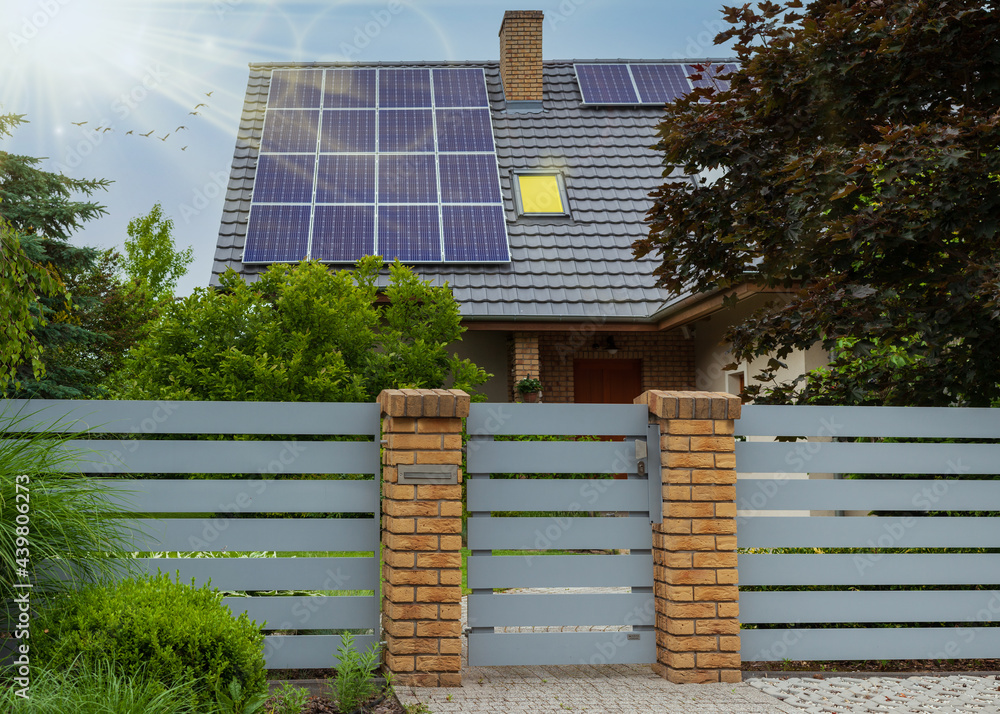Solar panels on a roof. Modern house and solar energy. Rays of the sun ...