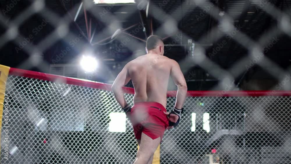 Muscular MMA fighter has finished his training session. Fighter takes ...