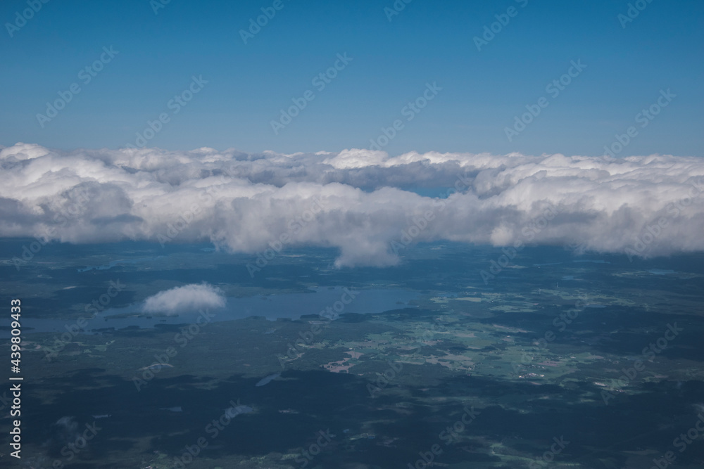 Aerial shot of a summer land with the clouds. 