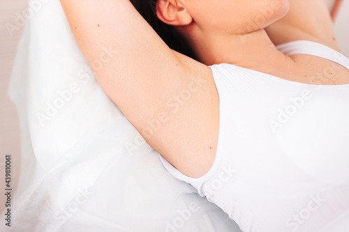 Epilation of the armpits a woman shows her armpits. Body care beauty women relaxing display of armpits without hair. Happy woman with smooth armpit skin after laser hair removal