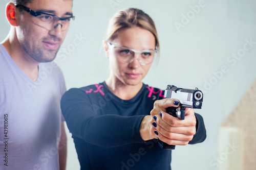 Stampa su tela A person target practicing with a handgun for self defense