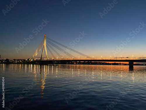 Cable-stayed bridge across the river. The bridge with night lighting. © Emils