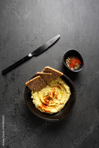 Obraz na płótnie Hummus bowl with red smoked paprika and multigrain bread