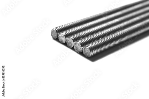 Foto Stainless steel threaded rod on white background.